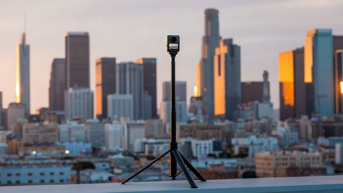 DJI Osmo 360 camera on a tripod in a city